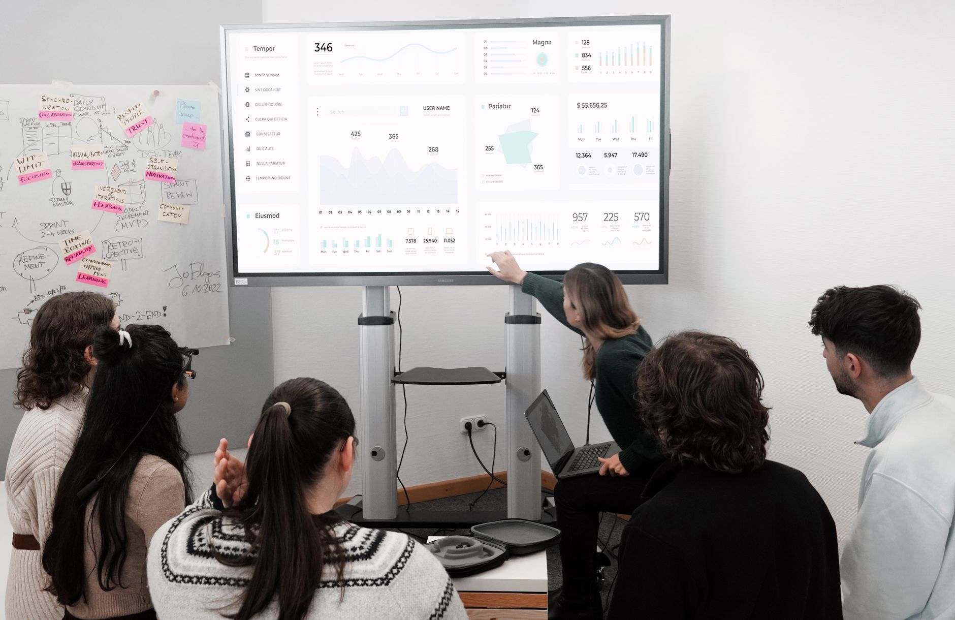 Product team reviewing AI-generated themes from user feedback on a laptop